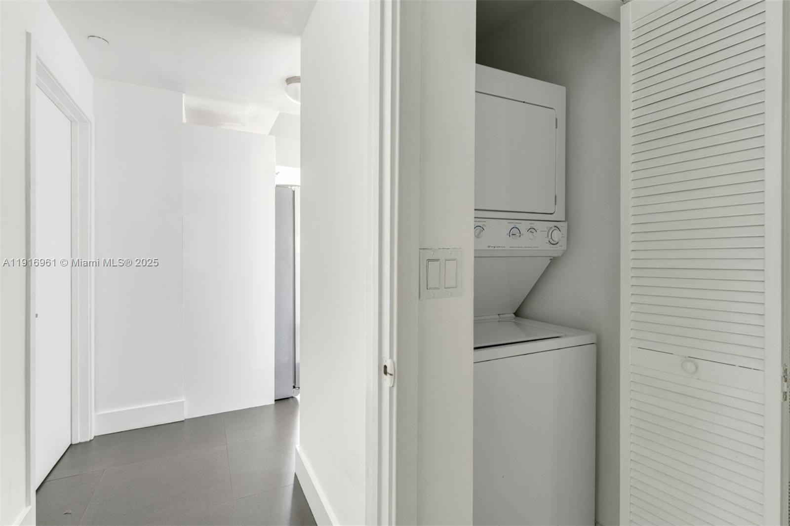 888 Biscayne Boulevard, Unit 1704 Miami, FL 33132 - Photo 14 of 20 a view of a hallway with a refrigerator