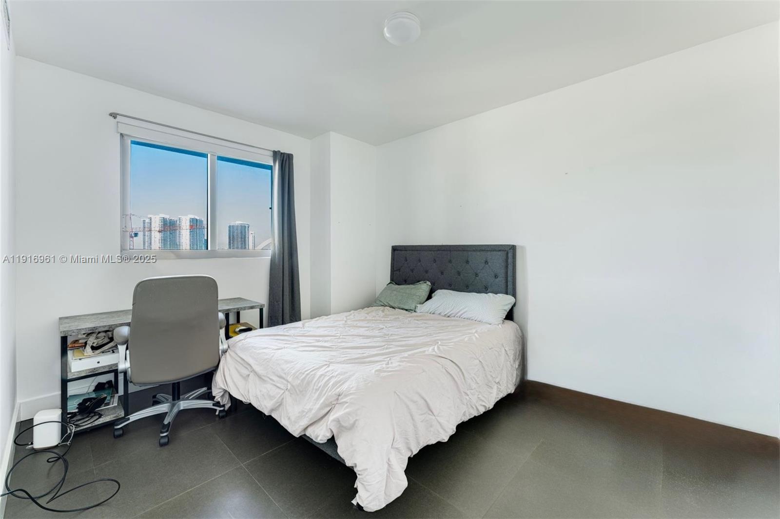 888 Biscayne Boulevard, Unit 1704 Miami, FL 33132 - Photo 15 of 20 a bedroom with a bed chair and a window