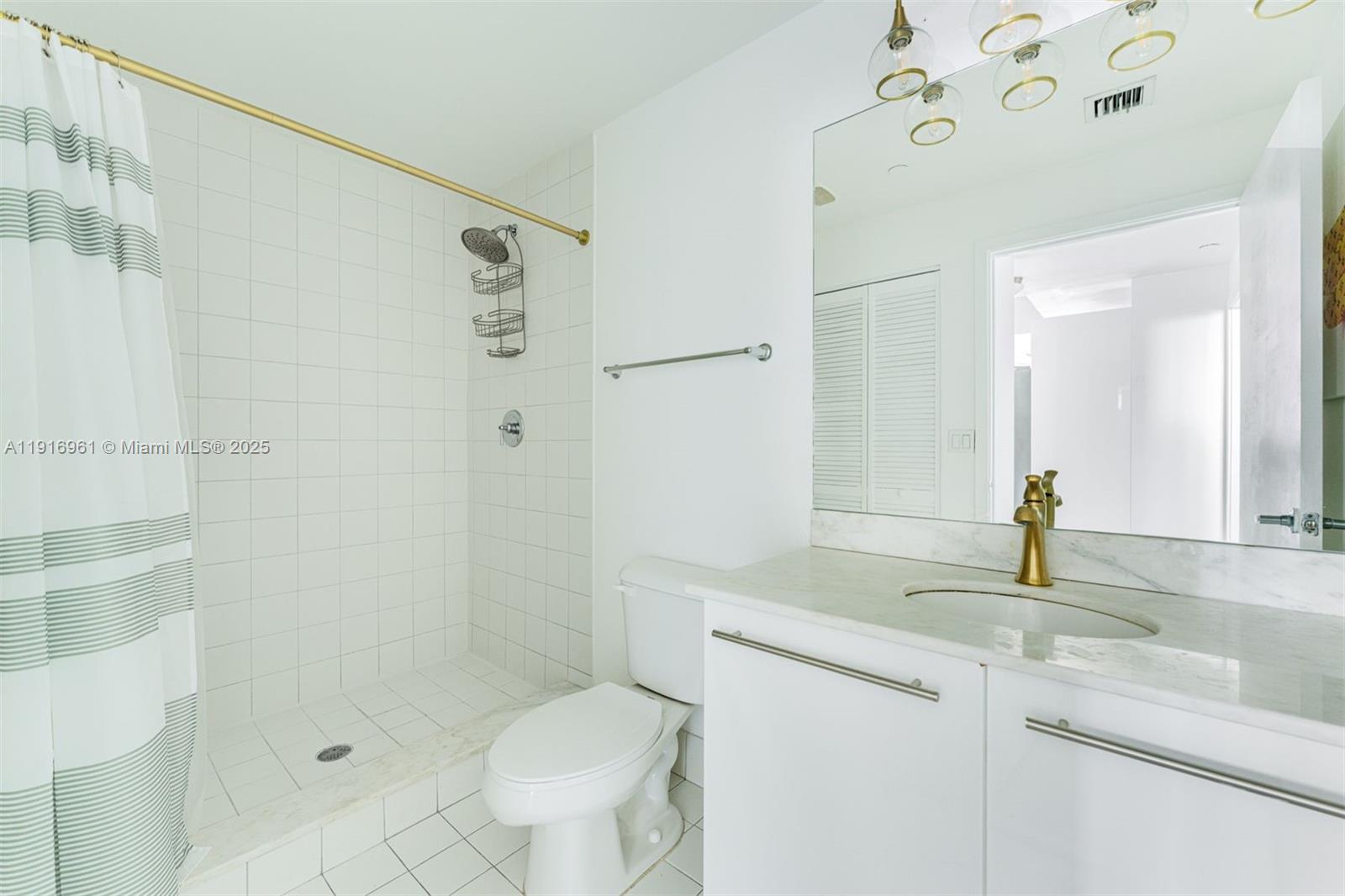 888 Biscayne Boulevard, Unit 1704 Miami, FL 33132 - Photo 16 of 20 a bathroom with a sink a toilet and shower