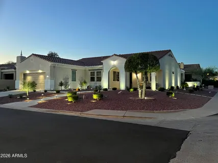 a front view of a house with yard and parking