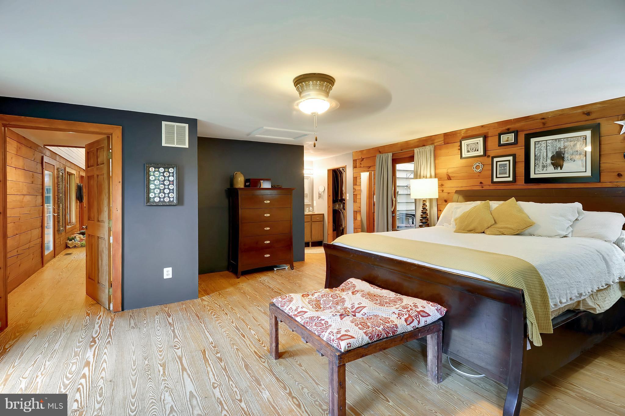 401 Farmington Road West Accokeek, MD 20607 - Photo 11 of 30 a spacious bedroom with a bed and a table