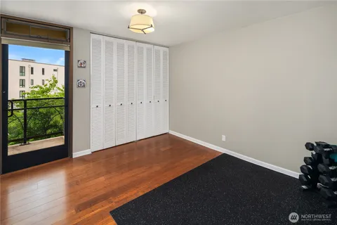 a spacious bedroom with a bed and large windows