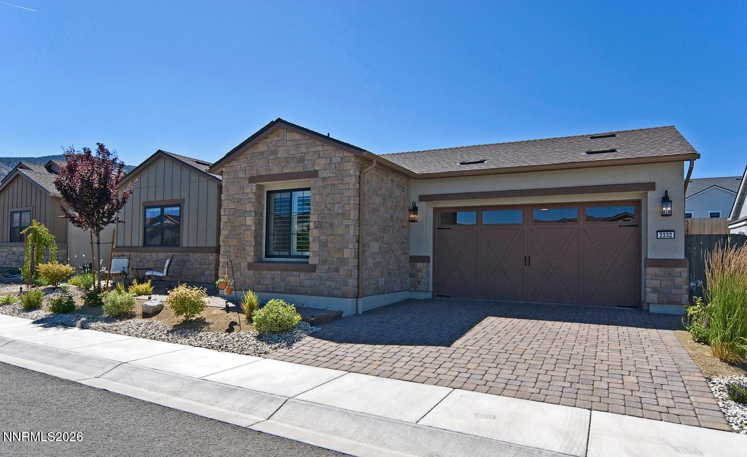2332 Hammer Falls Drive Reno, NV 89521 - Photo 5 of 57 a front view of a house with flowers