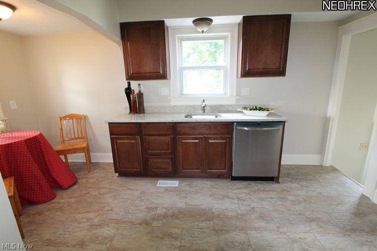 7103 Snow Road Parma, OH 44129 - Photo 9 of 23 Granite Countertops, stainless dishwasher, sink and faucet