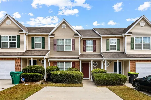 a front view of a house with a yard