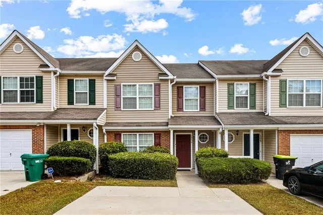 a front view of a house with a yard