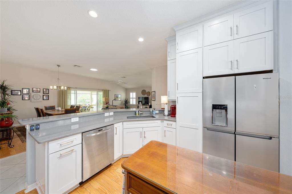 1348 Honea Path The Villages, FL 32162 - Photo 32 of 82 a kitchen with white cabinets and stainless steel appliances