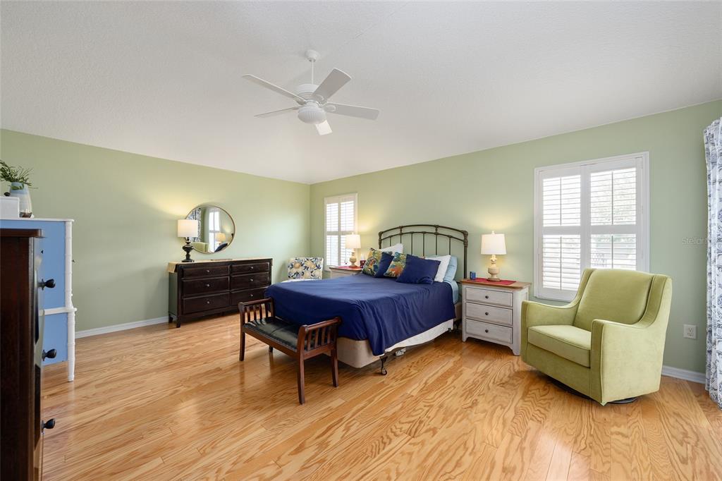 1348 Honea Path The Villages, FL 32162 - Photo 36 of 82 a spacious bedroom with a bed and wooden floor
