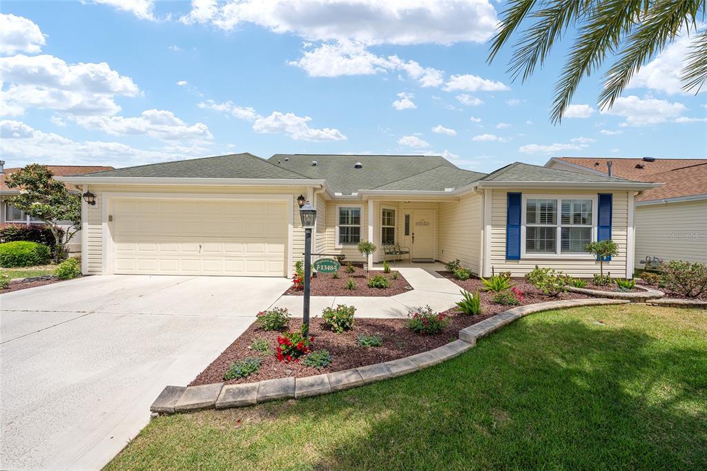 1348 Honea Path The Villages, FL 32162 - Photo 6 of 82 a front view of a house with swimming pool and yard with seating space