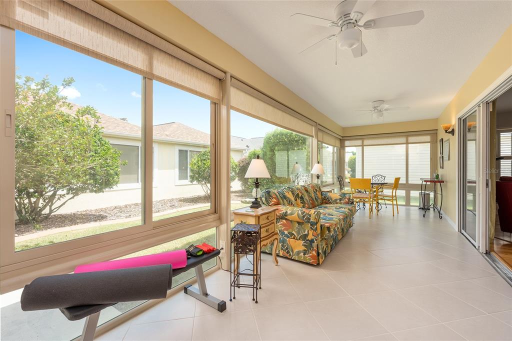 1348 Honea Path The Villages, FL 32162 - Photo 61 of 82 a living room with furniture and floor to ceiling windows