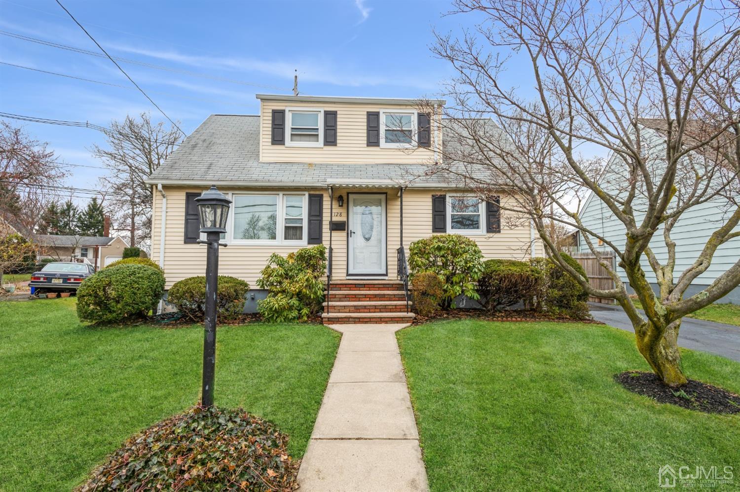 128 Old Post Road Edison, NJ 08817 - Photo 1 of 24 a front view of a house with a garden