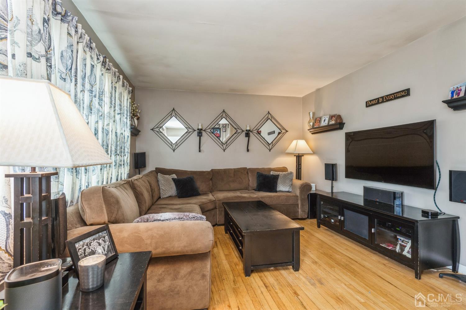 128 Old Post Road Edison, NJ 08817 - Photo 2 of 24 a living room with furniture and a flat screen tv