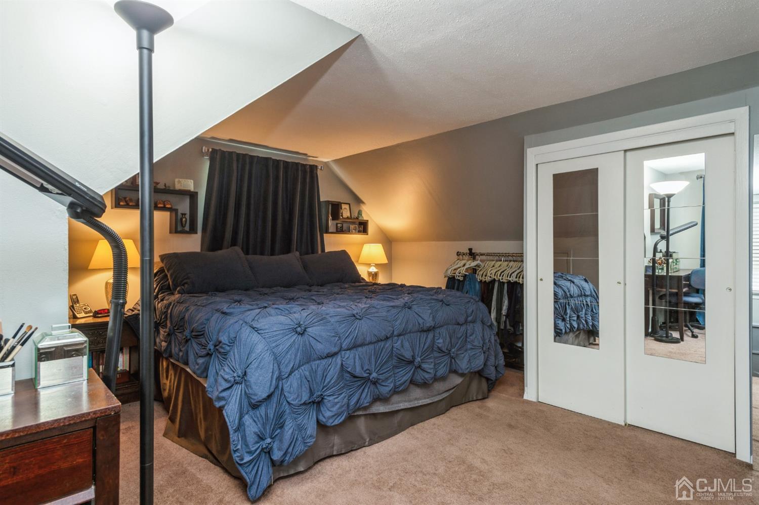 128 Old Post Road Edison, NJ 08817 - Photo 14 of 24 a bedroom with a bed a mirror on dresser and a wooden floor