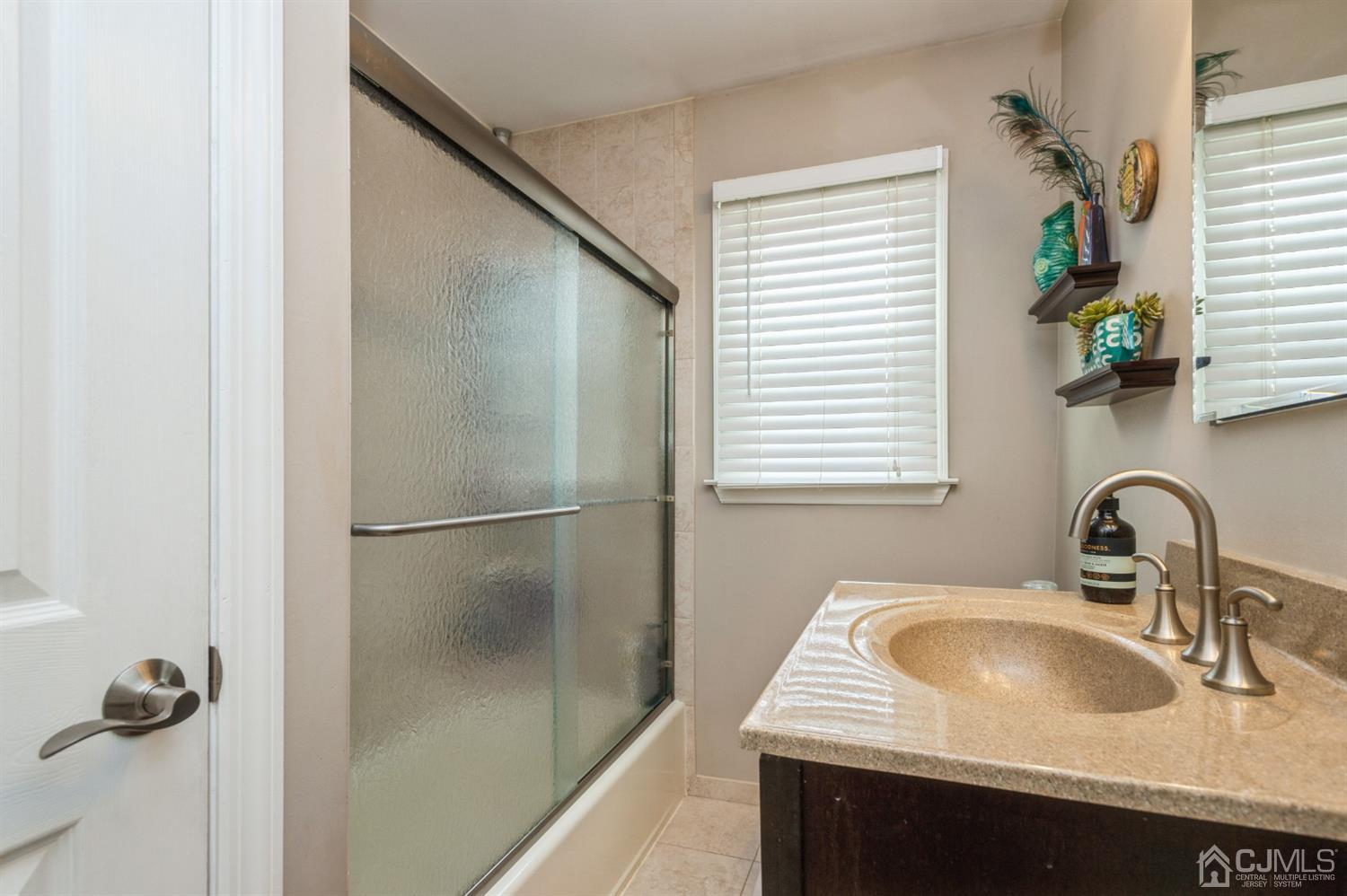 128 Old Post Road Edison, NJ 08817 - Photo 17 of 24 a bathroom with a sink and a window