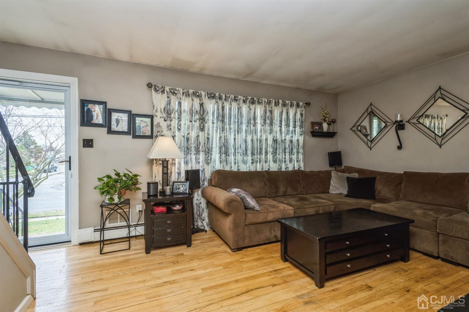 128 Old Post Road Edison, NJ 08817 - Photo 3 of 24 a living room with furniture and wooden floor