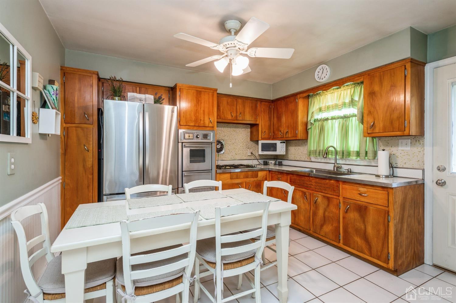 128 Old Post Road Edison, NJ 08817 - Photo 6 of 24 a kitchen with stainless steel appliances granite countertop a stove a sink a refrigerator with a dining table and chairs