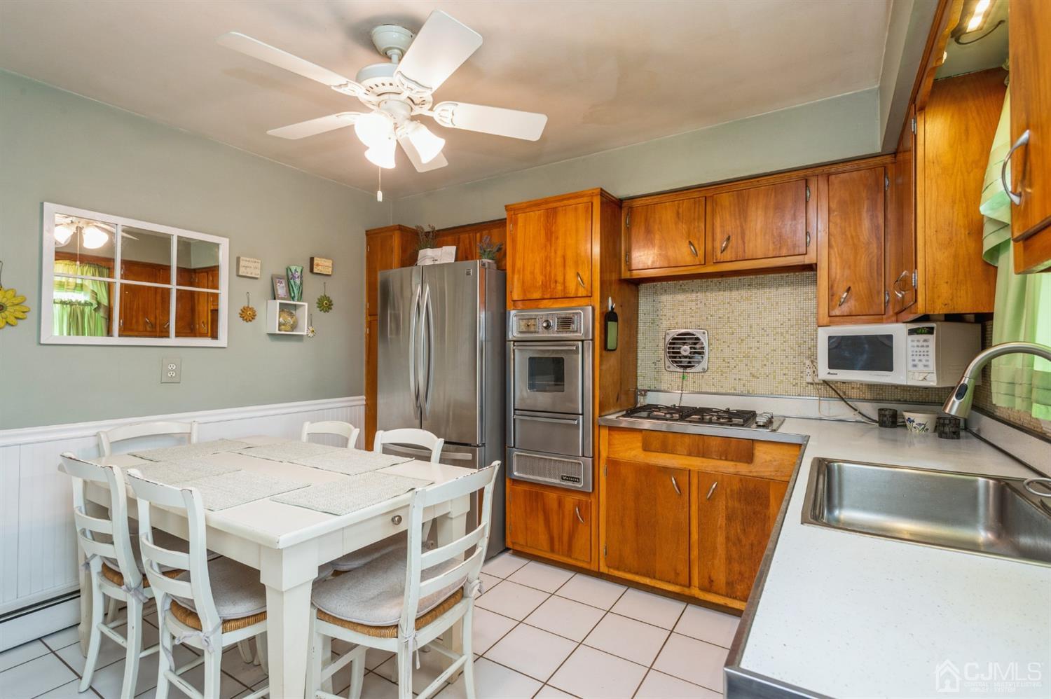 128 Old Post Road Edison, NJ 08817 - Photo 7 of 24 a kitchen with stainless steel appliances granite countertop a stove a refrigerator a sink dishwasher with a dining table and chairs