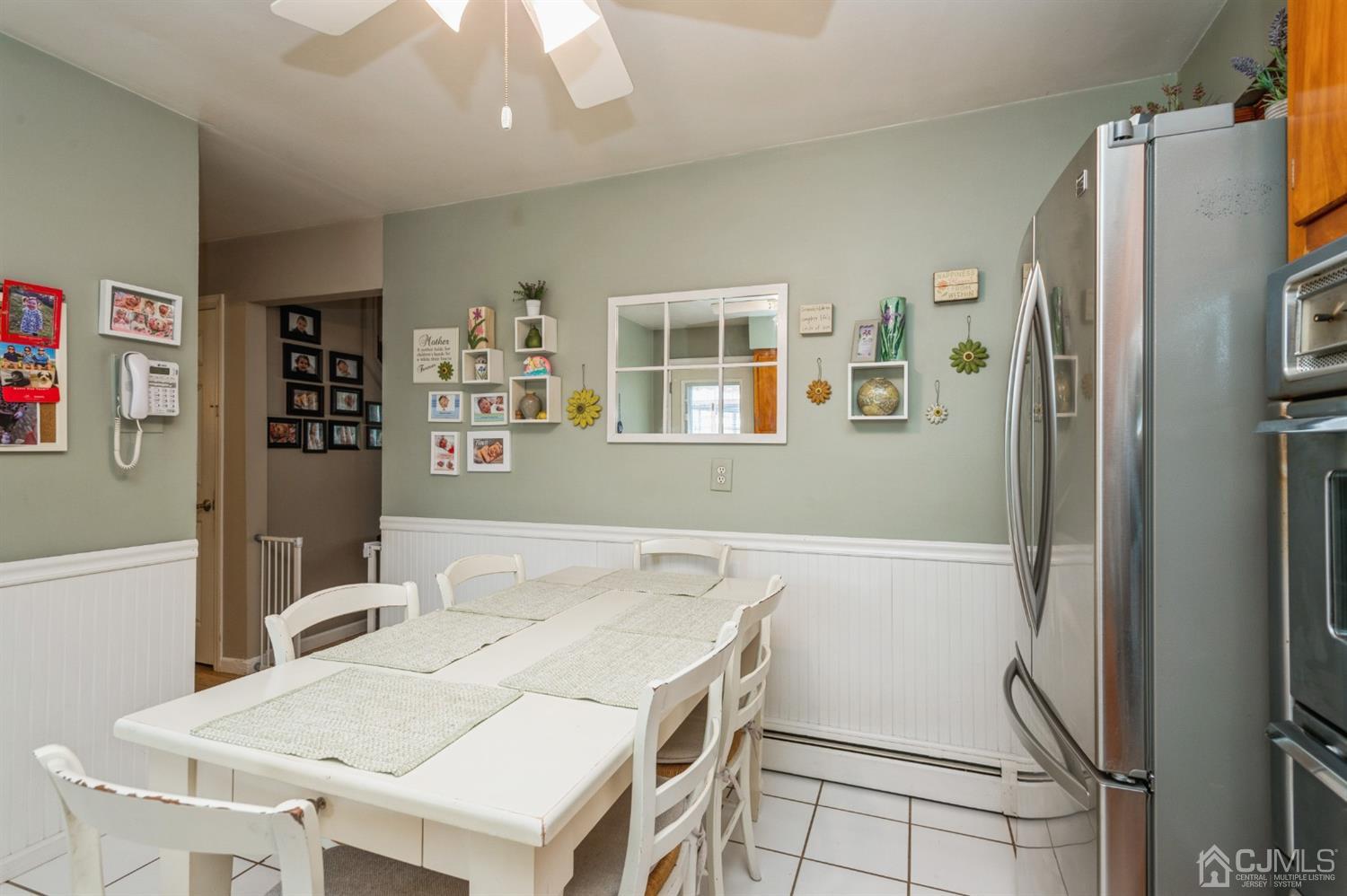 128 Old Post Road Edison, NJ 08817 - Photo 8 of 24 a kitchen with a table chairs and refrigerator