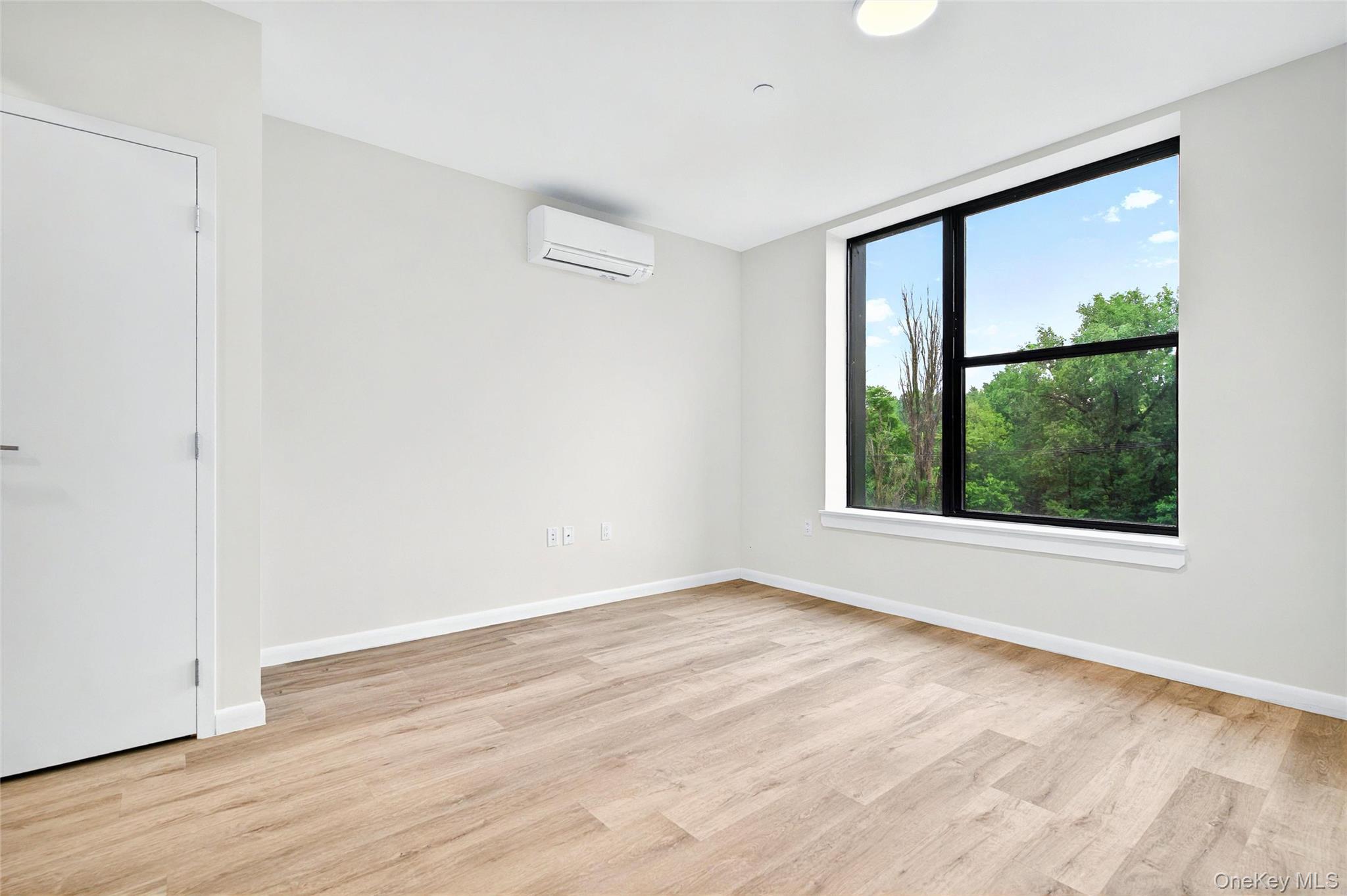1731 Lacombe Avenue, Unit 3A Bronx, NY 10473 - Photo 11 of 29 a view of an empty room with wooden floor and a window