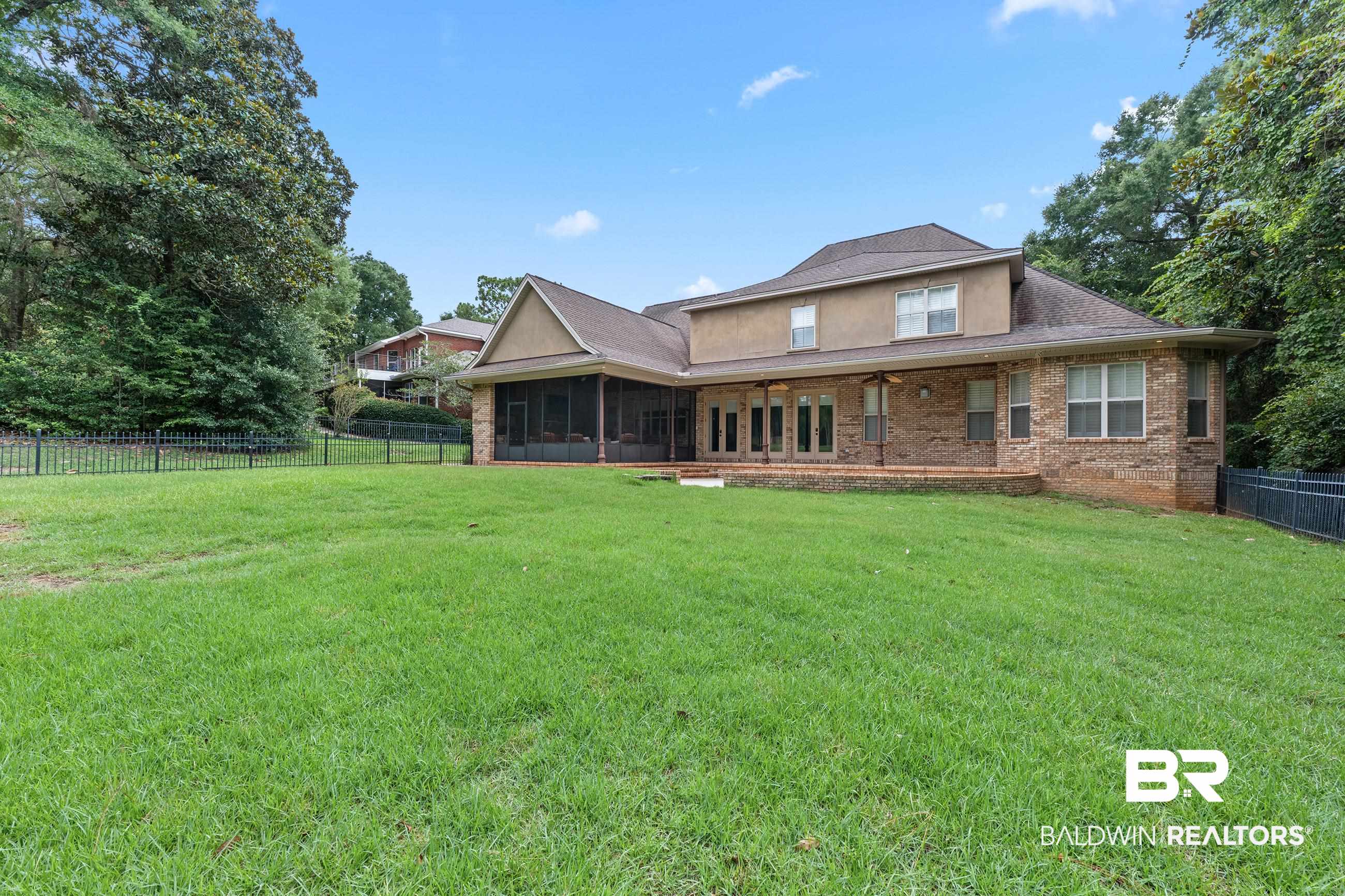 30463 Dolive Ridge Daphne, AL 36527 - Photo 16 of 58 Expansive green lawn with a full brick exterior and a screened porch