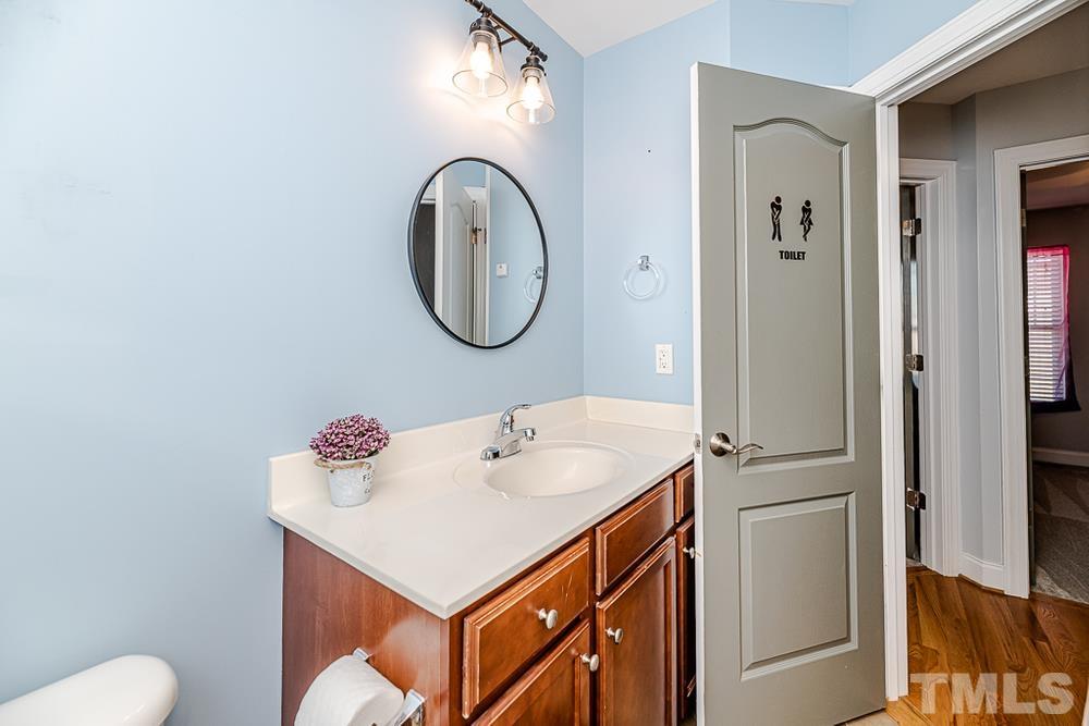 1652 Tingen Road Lillington, NC 27546 - Photo 15 of 30 a bathroom with a sink and a mirror