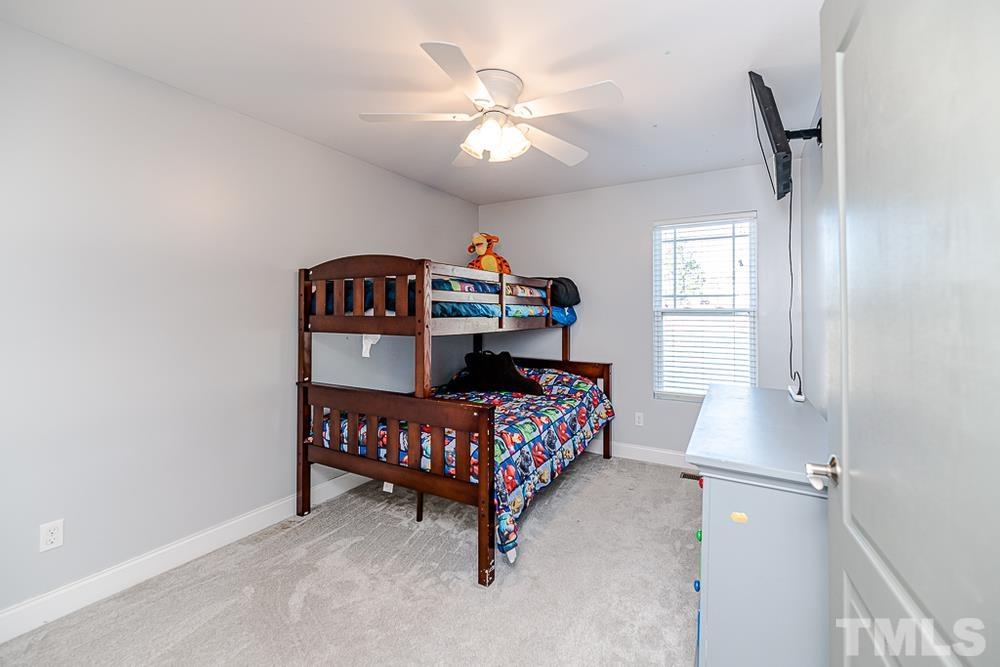 1652 Tingen Road Lillington, NC 27546 - Photo 17 of 30 a bedroom with furniture and a chandelier fan