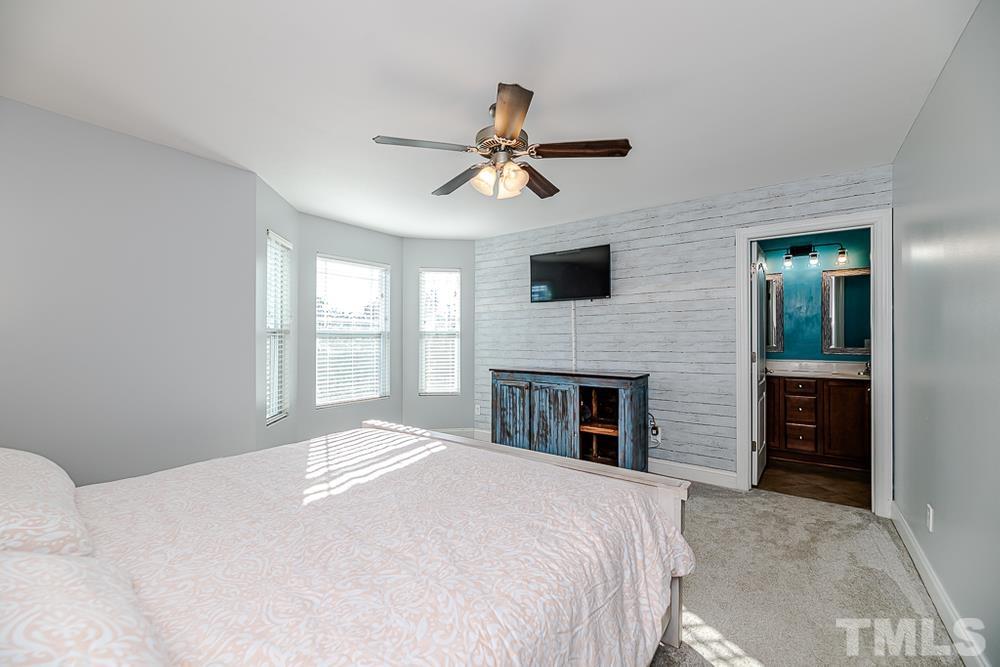 1652 Tingen Road Lillington, NC 27546 - Photo 19 of 30 a bedroom with a bed and a fireplace