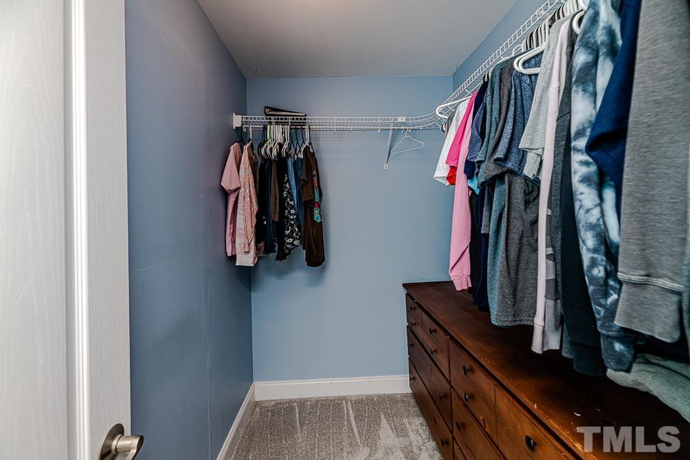 1652 Tingen Road Lillington, NC 27546 - Photo 20 of 30 a view of walk in closet with clothes