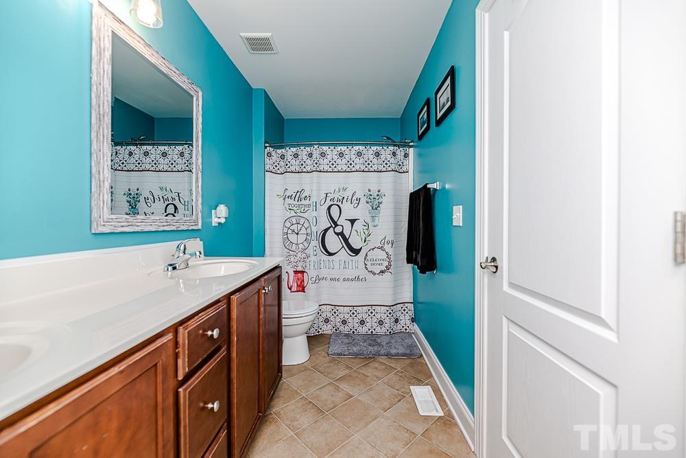 1652 Tingen Road Lillington, NC 27546 - Photo 22 of 30 a bathroom with a sink and a bathtub