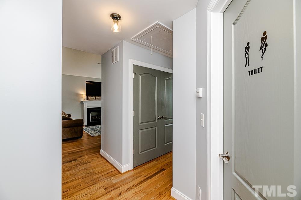 1652 Tingen Road Lillington, NC 27546 - Photo 25 of 30 a view of a hallway with wooden floor and closet