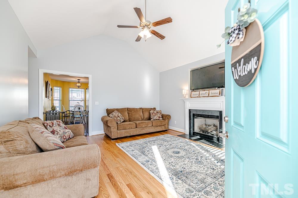1652 Tingen Road Lillington, NC 27546 - Photo 4 of 30 a living room with furniture a flat screen tv and a fireplace