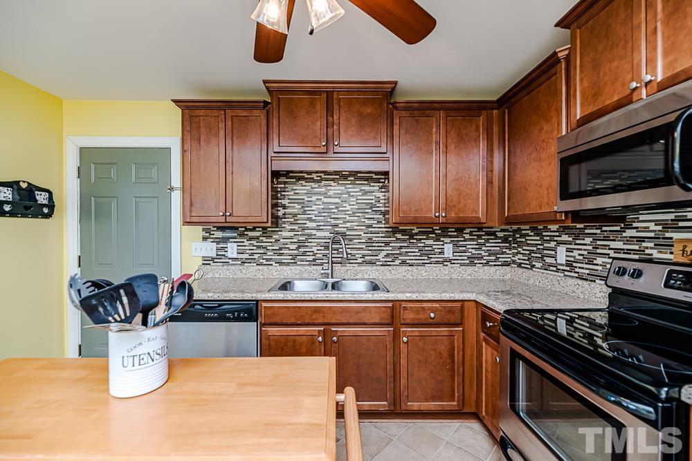 1652 Tingen Road Lillington, NC 27546 - Photo 8 of 30 a kitchen with a stove and a microwave