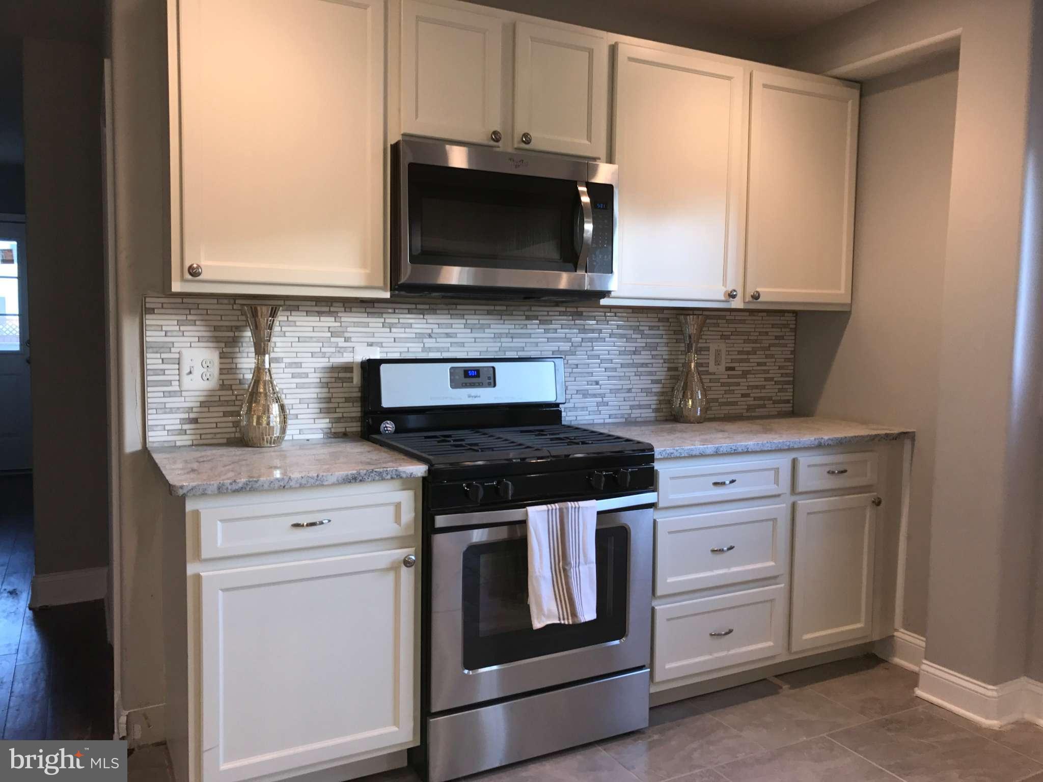 3227 Grace Road Baltimore, MD 21219 - Photo 5 of 19 a stove top oven sitting inside of a kitchen