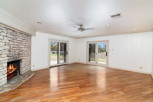 a view of an empty room with window and fire place
