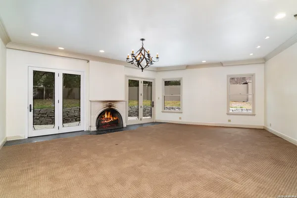 a view of a livingroom with a ceiling fan and window