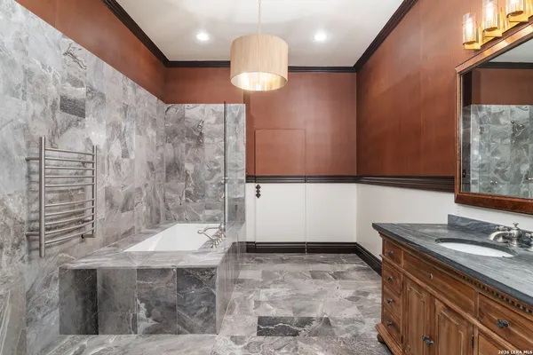 a bathroom with a sink a mirror and a bathtub