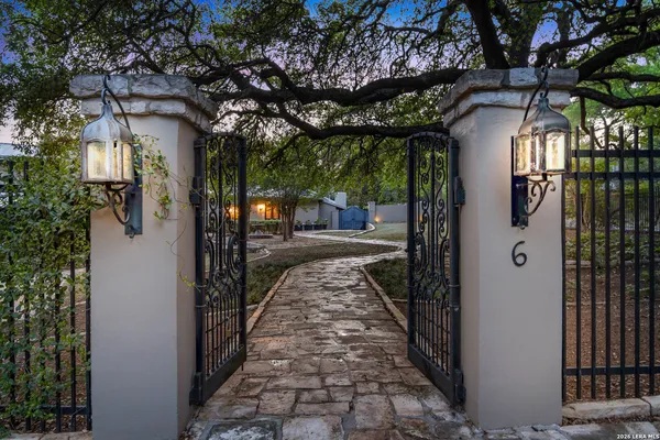 a view of a pathway of a house with a tree