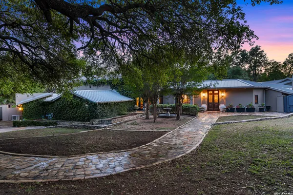a view of a house with yard and sitting area