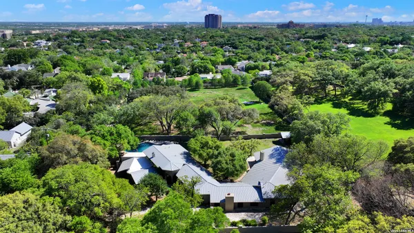 an aerial view of a house with a yard