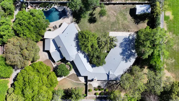 an aerial view of a house with outdoor space