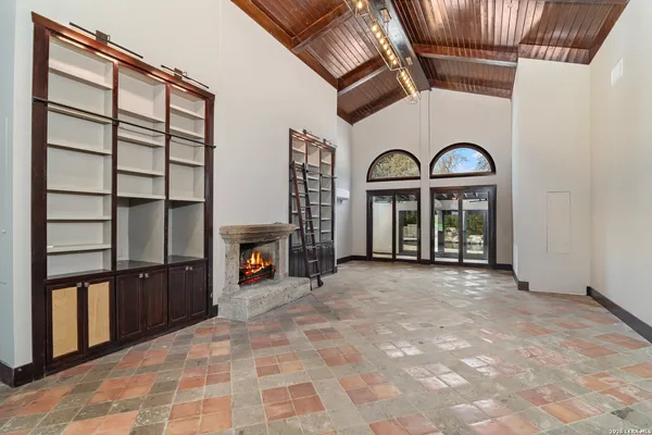 a view of a livingroom with furniture fridge and hallway