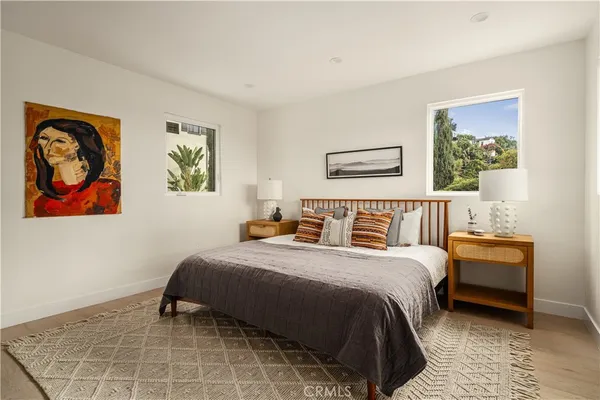 a bedroom with a bed and a painting on the wall