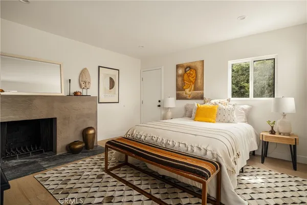 a bedroom with a bed and a fireplace