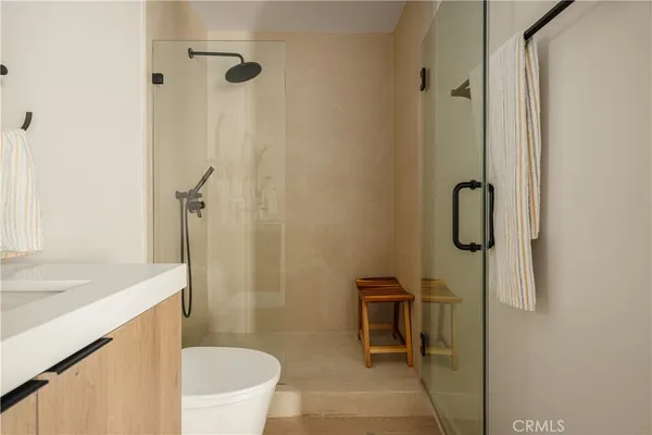 a bathroom with a sink a toilet and shower