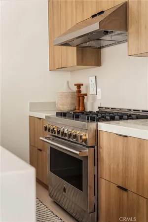 a stove top oven sitting inside of a kitchen