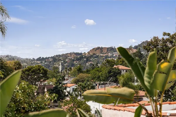 a view of a house with a swimming pool and a yard