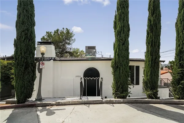 front view of a house with potted plants