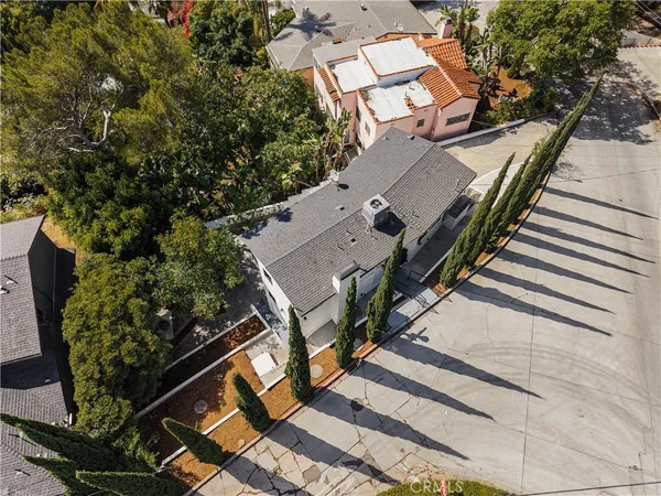 an aerial view of a house with a yard and potted plants