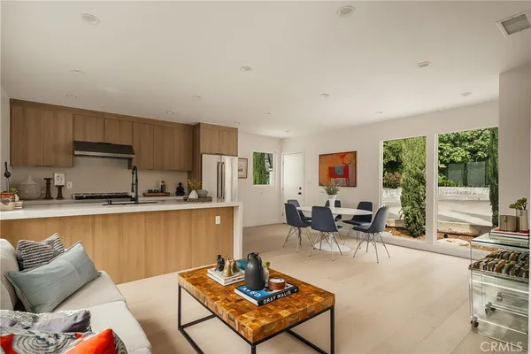 a living room with furniture a flat screen tv and a large window