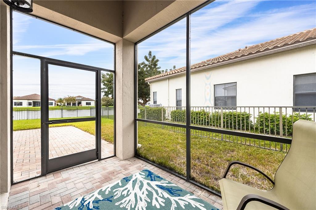 5116 Salerno Street Ave Maria, FL 34142 - Photo 28 of 36 Sunroom featuring a water view and a residential view